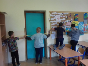 uczniowie mierzą długość sali